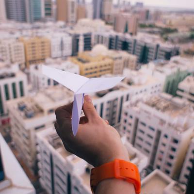 Paper airplane over houses